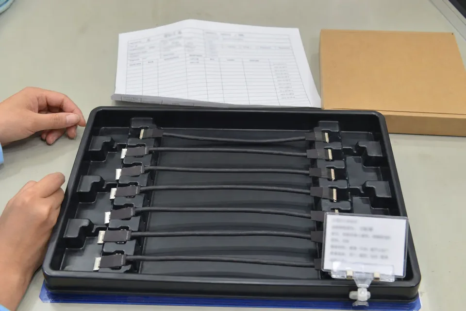 Batch lot tray and release-record staging for a non-branded I-PEX 20455-compatible eDP harness program, lot card and packaging sleeve visible