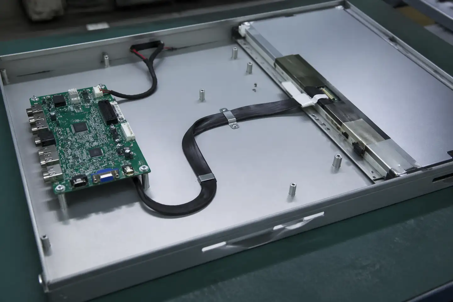 eDP cable assembly routed inside an industrial display monitor chassis with board and panel context