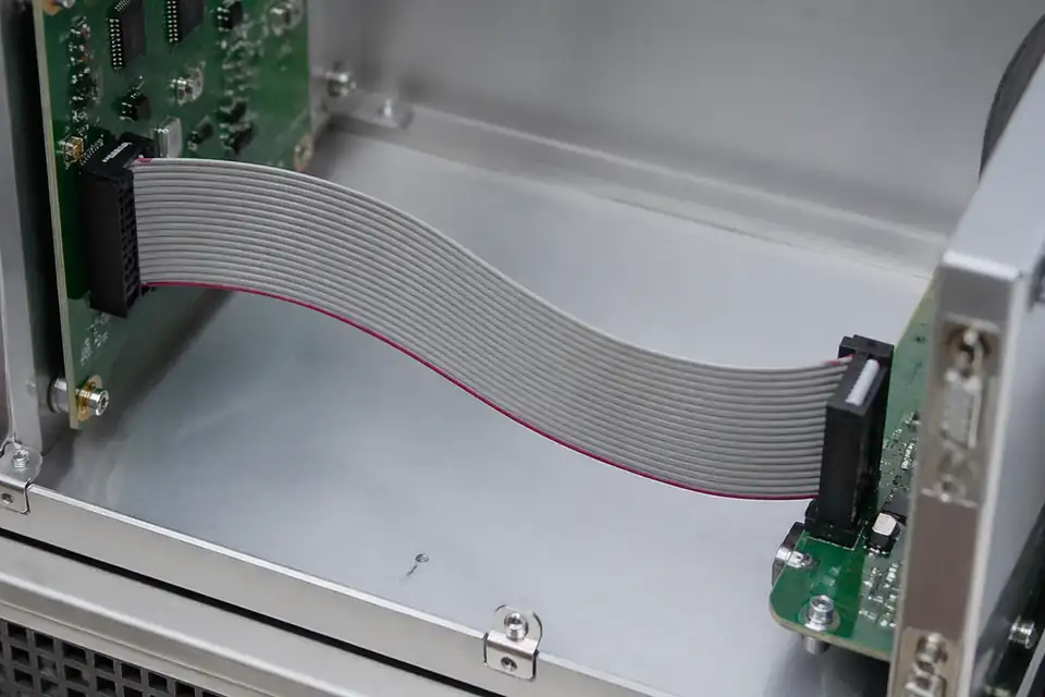 Ribbon IDC assembly used as a board-extension ribbon path