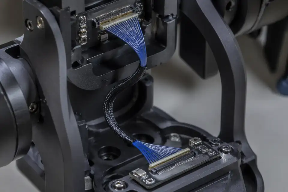 Micro-coaxial harness inside a gimbal signal interconnect with repeated-motion bend zone